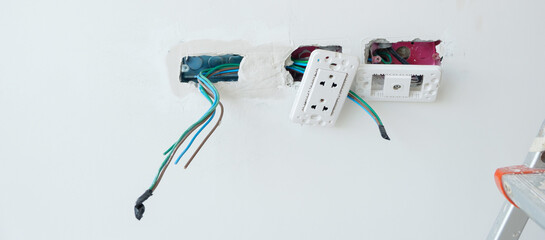 Electrical Wiring under plaster, hidden installation cables for socket to a concrete. Renovation, Repair and development of home and apartment concepts