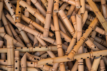 Pile of half-finished bamboo flutes, handmade bamboo flute production process by craftsmen, bamboo flutes being dried before finishing and marketed