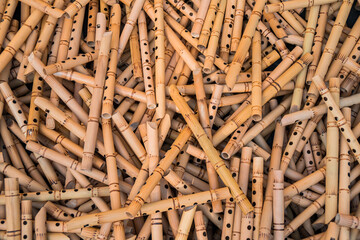 Pile of half-finished bamboo flutes, handmade bamboo flute production process by craftsmen, bamboo flutes being dried before finishing and marketed