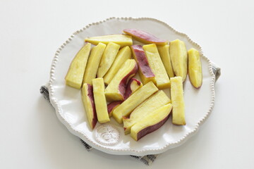 micro-wave cooked sweet potato on white plate for cooking image 