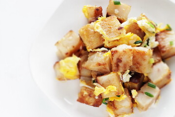 Chinese food, turnip cake and egg stir fried with green onion 