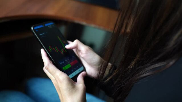 crypto currency trading. phone in hands with ethereum chart. online trading. woman checks the ethereum price chart on a digital exchange on a smartphone.