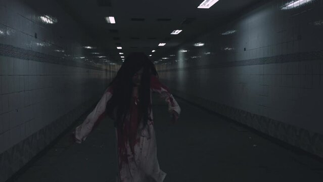 Scary zombies ghost walking. Asian woman ghost horror creepy scary have hair covering face with blood walk following camera at abandoned dark tone, female makeup zombie, Happy Halloween day