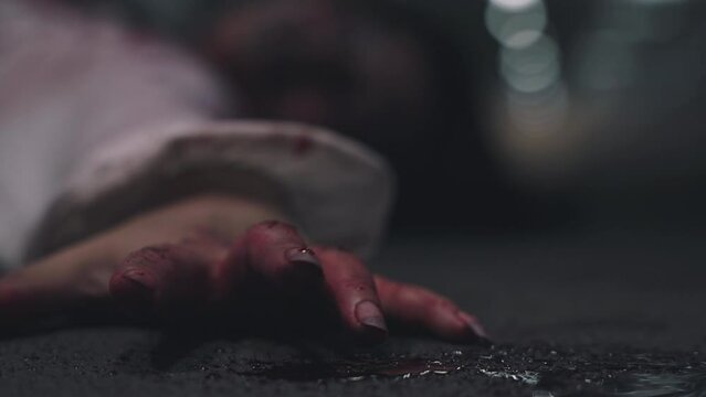Closeup hand with blood of horror bloodthirsty ghost woman on floor, Homicide female hands jerky in blood with resentment torture and ask for help, murder and crime, Halloween horror day concept