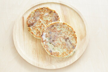 Japanese frozen food, okonomiyaki on wooden plate 