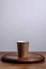 Coffee cardboard cup on wooden background