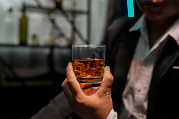 Closeup businessmen holding a glass of whiskey