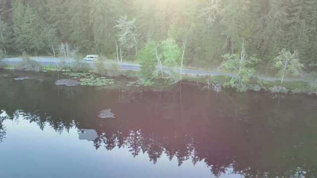 Aerial shot of a road running parallel to a beautiful lake in Washington State.