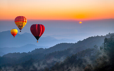 Hot air balloon above high mountain at sunset, sunrise. Colorful hot air balloons flying over Doi Luang Chiang Dao at sunrise Chiang mai, Thailand. Sport and recreation - Powered by Adobe