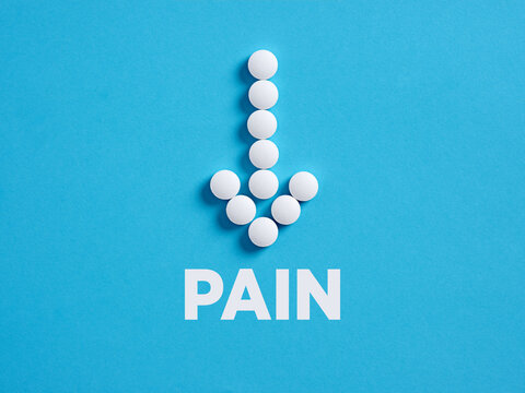 Medical pills in arrow shape with the word pain. Painkiller or reducing pain