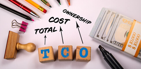 TCO Total Cost of Ownership. Office objects and money on a white background
