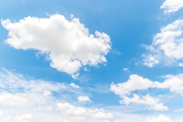 Naklejka na ściany i meble Beautiful white fluffy clouds in blue sky. Nature background from white clouds in sunny day