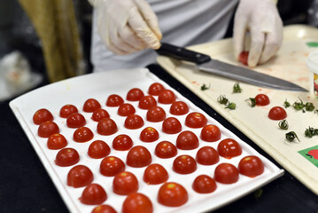 The chef prepares snack foods consisting of tomatoes