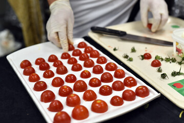 The chef prepares snack foods consisting of tomatoes