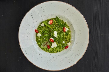Risotto with spinach and cheese. Food from the chef in a restaurant or cafe.