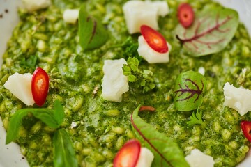 Risotto with spinach and cheese. Food from the chef in a restaurant or cafe.