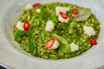 Risotto with spinach and cheese. Food from the chef in a restaurant or cafe.