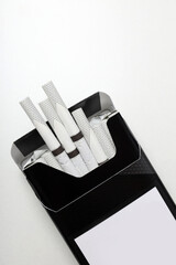 Concept of harm of smoking, pack of cigarettes on white background