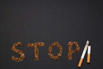 Concept of harm of smoking, text Stop made of tobacco and cigarettes on black background
