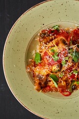 Pasta with chicken, zucchini and mushrooms with red sauce. Food from the chef in a restaurant or cafe.
