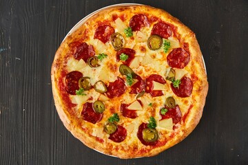 Pasta with salami, olives and pineapples. Food from the chef in a restaurant or cafe.