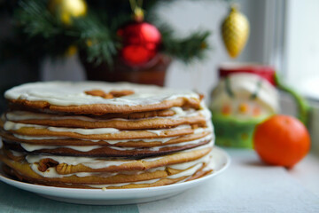 Christmas cake on the window on the background of the Christmas tree