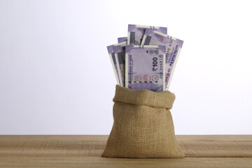 Rupees Hundred note in a jute sack, Concept.