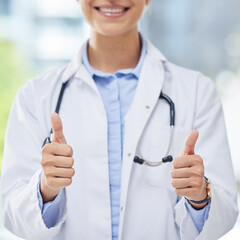 Healthcare, woman and thumbs up from doctor with a smile and blurred background. Success, thank you...
