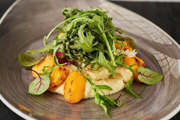 Baked fish with fruits and herbs. Food from the chef in a restaurant or cafe.