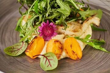 Baked fish with fruits and herbs. Food from the chef in a restaurant or cafe.