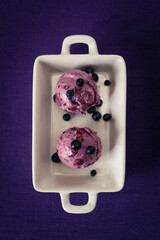 blueberry icecreame cones on a white plate froma bove