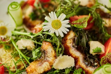 Salad of eels and fried zucchini. Food from the chef in a restaurant or cafe.
