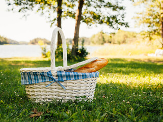 picnic basket with bread by the sea