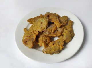 Deep fried salted fish on blurred white plate isolated on white background