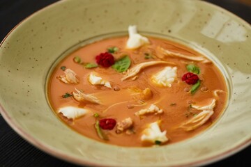 Tomato soup with chicken. Food from the chef in a restaurant or cafe.