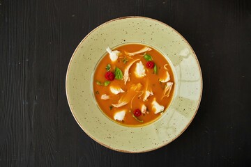 Tomato soup with chicken. Food from the chef in a restaurant or cafe.