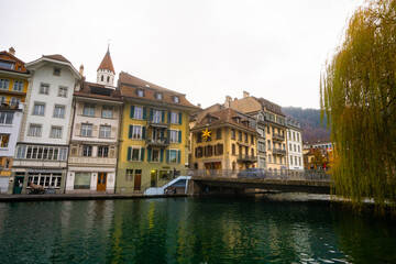 Beautiful view , medieval buildings , Aare lake and street in old town of Thun during autumn , winter cloudy day : Thun , Switzerland : December 2 , 2019