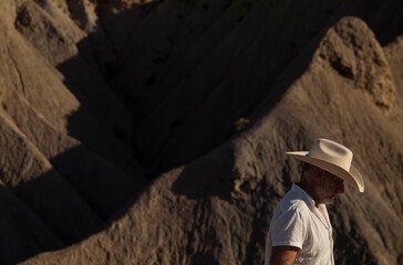 Adult man in cowboy hat in desert. Almeria, Spain