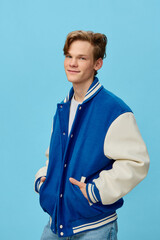handsome, fashionable guy posing in a bomber jacket holding his hands in his pockets
