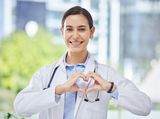 Heart, hand and icon with happy doctor in medical clinic or hospital. Happy, health and safety in...