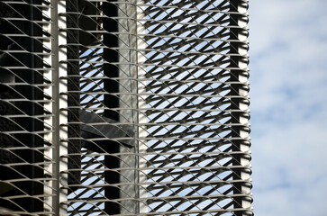 steel cladding of a building with a expanded metal lattice structure. galvanized gray nets protect...