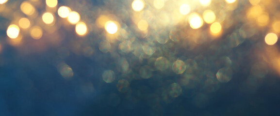 background of abstract glitter lights. gold, blue and black. de focused