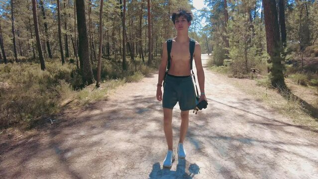 total wide front shot young shirtless teenage walking in forest in fontainebleau