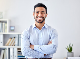 Portrait of a businessman with a smile in a corporate modern office of a startup company. Happy,...