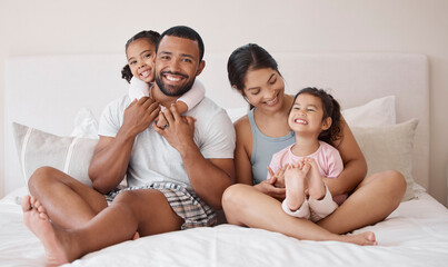 Portrait, happy and family in bed with smile, hug and love while relax in the morning. Parents...