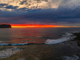 Fototapeta na wymiar Cloud filled sunrise seascape