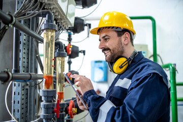 Portrait of caucasian worker checking PH level and quality of water in production water factory.