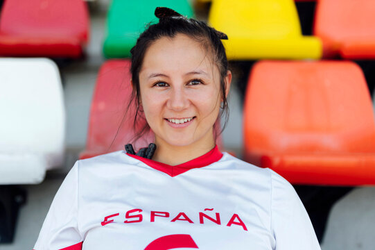 Smiling young player wearing sports jersey at stadium