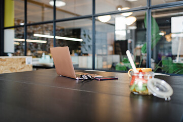 Laptop and fruits on table in office
