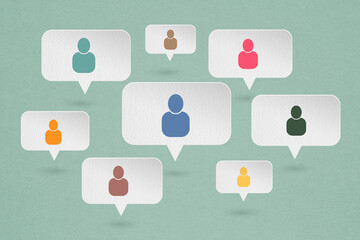 Concept of online communication or social networking. grunge white   speech bubbles paper cut with multi color people icon on grunge green background